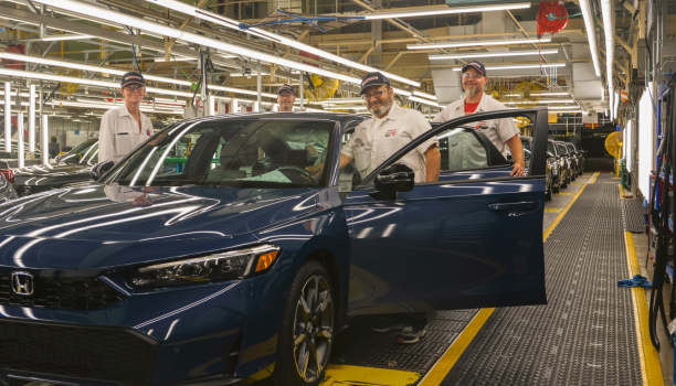 A Honda empoyee inspects a vehicle on the line.