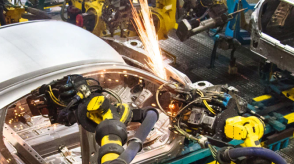 Robotic welding machine is pictured welding a vehicle. 