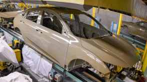 A vehicle is being given a topcoat in a Honda manufacturing facility. 