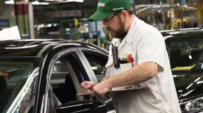 A Honda employee performs an inspection of a Honda vehicle. 