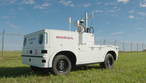 A prototype of a Honda Autonomous Work Vehicle is depicted.